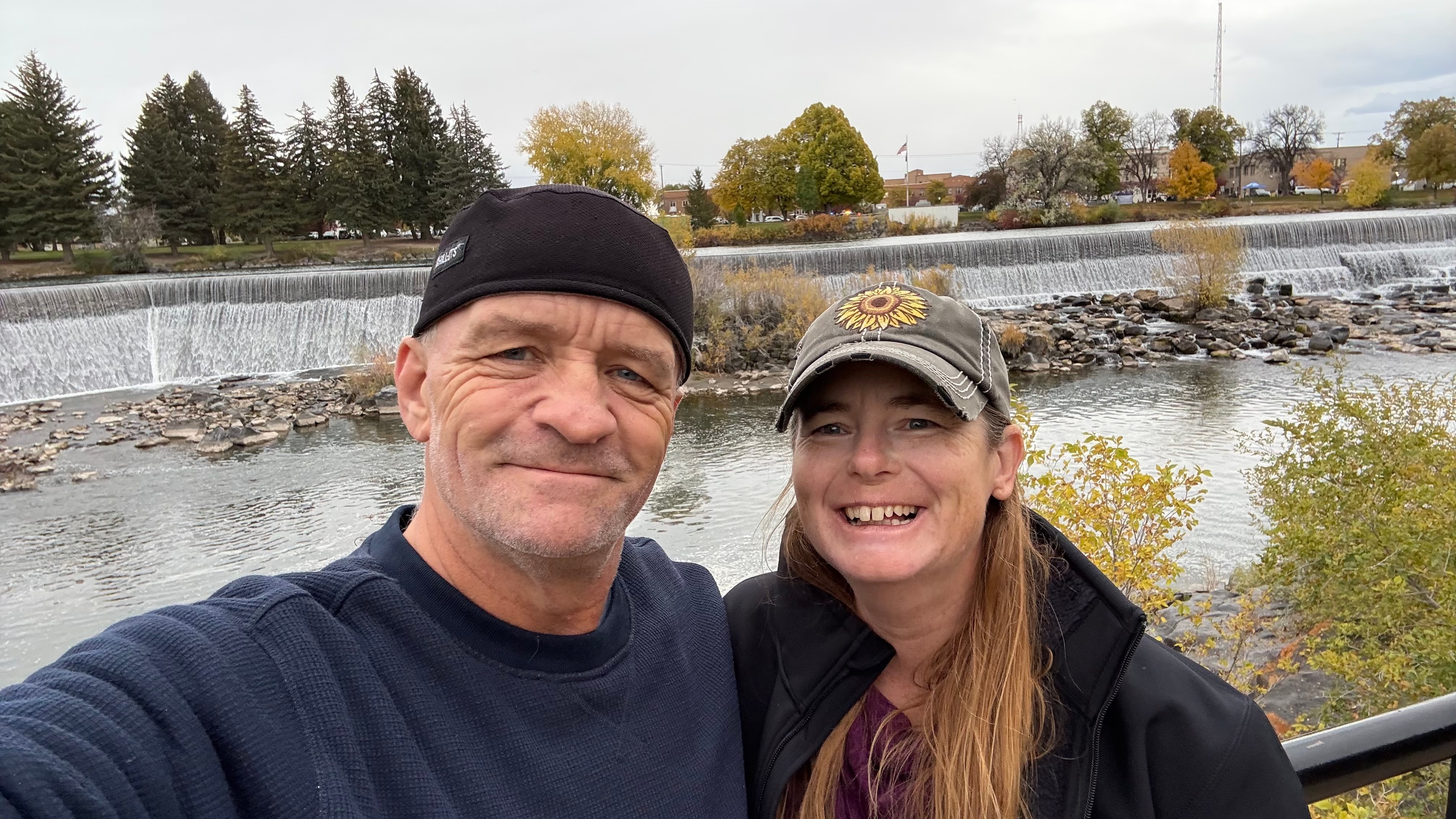 Ray and Susan smiling beside a waterfall