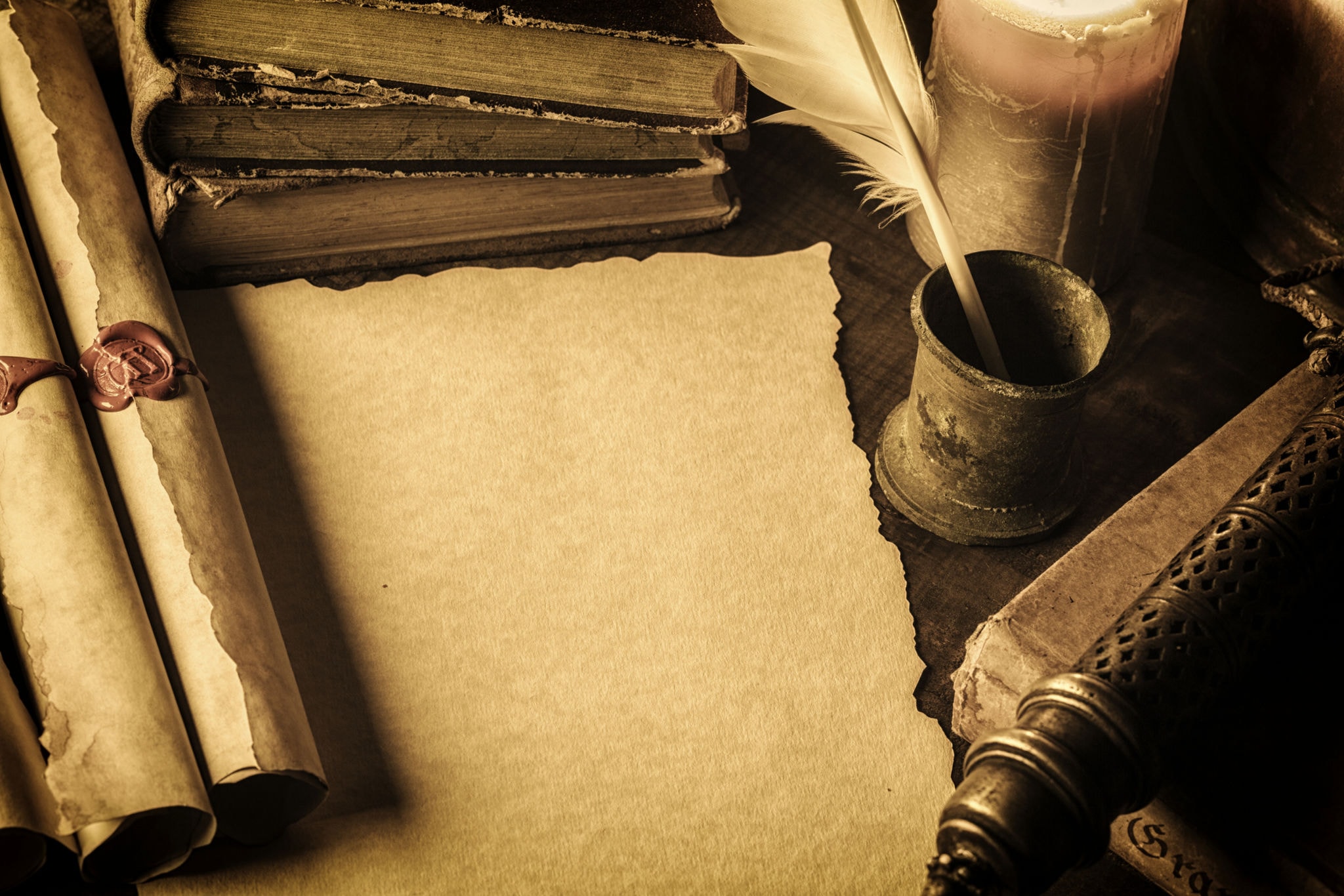 Antique parchment, books, and quill